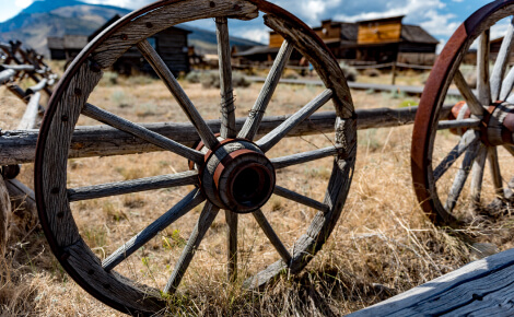 Old wagon wheels on a wooden fence